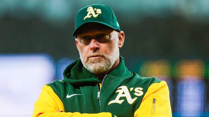 Apr 22, 2026; Seattle, Washington, USA; Athletics manager Mark Kotsay (7) talks with staff in the dugout following a batted ball that was trapped in the jersey of Seattle Mariners starting pitcher Logan Gilbert (36, not pictured) during the first inning at T-Mobile Park. The play was ruled a hit. Mandatory Credit: Joe Nicholson-Imagn Images Apr 22, 2026; Seattle, Washington, USA; Athletics manager Mark Kotsay (7) talks with staff in the dugout following a batted ball that was trapped in the jersey of Seattle Mariners starting pitcher Logan Gilbert (36, not pictured) during the first inning at T-Mobile Park. The play was ruled a hit. Mandatory Credit: Joe Nicholson-Imagn Images