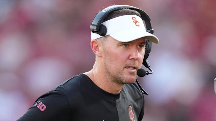Aug 30, 2025; Los Angeles, California, USA; Southern California Trojans head coach Lincoln Riley talks with Southern California Trojans quarterback Husan Longstreet (4) in the second half against the Missouri State Bears at United Airlines Field at Los Angeles Memorial Coliseum. Mandatory Credit: Kirby Lee-Imagn Images
