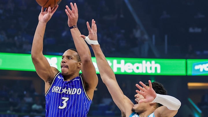 Apr 17, 2026; Orlando, Florida, USA; Orlando Magic guard Desmond Bane (3) shoots in front of Charlotte Hornets guard Josh Green (10) during the second quarter during the play-in rounds of the 2026 NBA Playoffs at Kia Center. Mandatory Credit: Mike Watters-Imagn Images