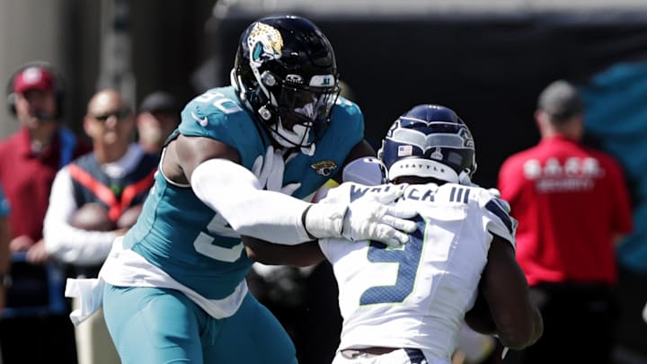 Oct 12, 2025; Jacksonville, Florida, USA; Jacksonville Jaguars defensive end Emmanuel Ogbah (90) tackles Seattle Seahawks running back Kenneth Walker III (9) during the first half at EverBank Stadium. Mandatory Credit: Travis Register-Imagn Images