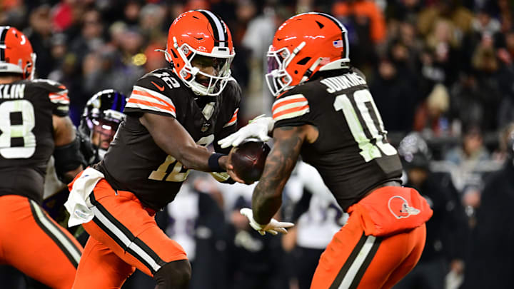 Nov 16, 2025; Cleveland, Ohio, USA; Cleveland Browns quarterback Shedeur Sanders (12) hands the ball off to running back Quinshon Judkins (10) during the fourth quarter against the Baltimore Ravens at Huntington Bank Field.