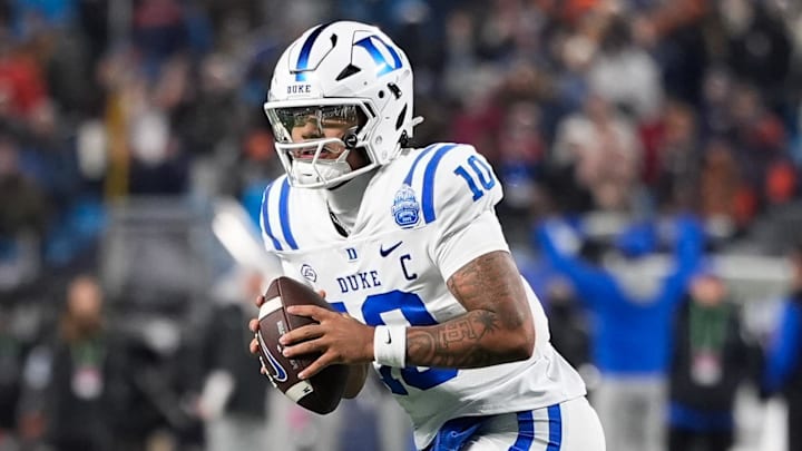 Dec 6, 2025; Charlotte, NC, USA; Duke Blue Devils quarterback Darian Mensah (10) looks to pass during over time against the Virginia Cavaliers during the 2025 ACC Championship game at Bank of America Stadium. Mandatory Credit: Jim Dedmon-Imagn Images Dec 6, 2025; Charlotte, NC, USA; Duke Blue Devils quarterback Darian Mensah (10) looks to pass during over time against the Virginia Cavaliers during the 2025 ACC Championship game at Bank of America Stadium. Mandatory Credit: Jim Dedmon-Imagn Images