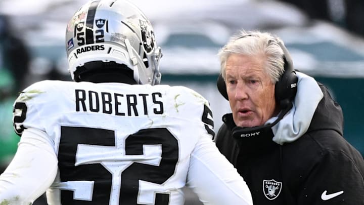 Dec 14, 2025; Philadelphia, Pennsylvania, USA; Las Vegas Raiders linebacker Elandon Roberts (52) talks with Head Coach Pete Carroll on the sidelines during the first quarter against the Philadelphia Eagles at Lincoln Financial Field. Mandatory Credit: Eric Hartline-Imagn Images