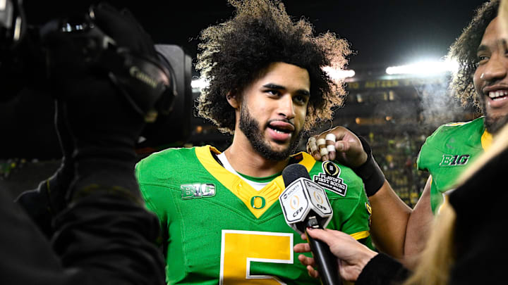 Dec 20, 2025; Eugene, OR, USA; Oregon Ducks quarterback Dante Moore (5) is interviewed after the game against the James Madison Dukes at Autzen Stadium. Mandatory Credit: Troy Wayrynen-Imagn Images Dec 20, 2025; Eugene, OR, USA; Oregon Ducks quarterback Dante Moore (5) is interviewed after the game against the James Madison Dukes at Autzen Stadium. Mandatory Credit: Troy Wayrynen-Imagn Images