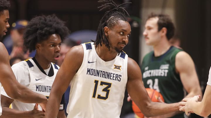 Nov 30, 2025; Morgantown, West Virginia, USA; West Virginia Mountaineers guard Chance Moore (13) celebrates with teammates after a play during the first half against the Mercyhurst Lakers at Hope Coliseum. Mandatory Credit: Ben Queen-Imagn Images