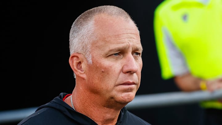 Aug 28, 2025; Raleigh, North Carolina, USA; North Carolina State Wolfpack head coach Dave Doeren walks out during the warmups prior to the game against East Carolina Pirates at Carter-Finley Stadium. Mandatory Credit: Jaylynn Nash-Imagn Images