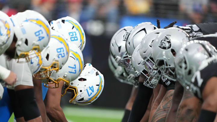 Jan 5, 2025; Paradise, Nevada, USA; Helmets at the line of scrimmage as Los Angeles Chargers long snapper Josh Harris (47) snaps the ball against the Las Vegas Raiders at Allegiant Stadium. Mandatory Credit: Kirby Lee-Imagn Images