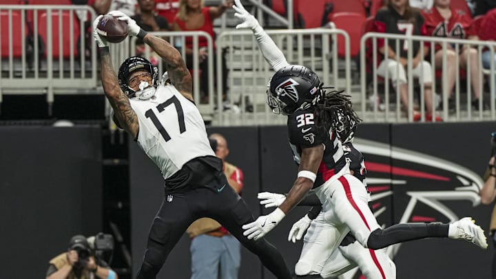 Aug 23, 2024; Atlanta, Georgia, USA; Jacksonville Jaguars tight end Evan Engram (17) catches a touchdown pass behind Atlanta Falcons cornerback Kevin King (32) during the first half at Mercedes-Benz Stadium. 