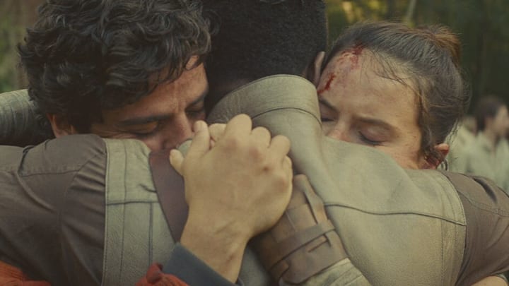 Star Wars Episode IX: The Rise of Skywalker. Poe Dameron, Finn, and Rey Skywalker hug after the Battle of Exegol. Image Credit: StarWars.com