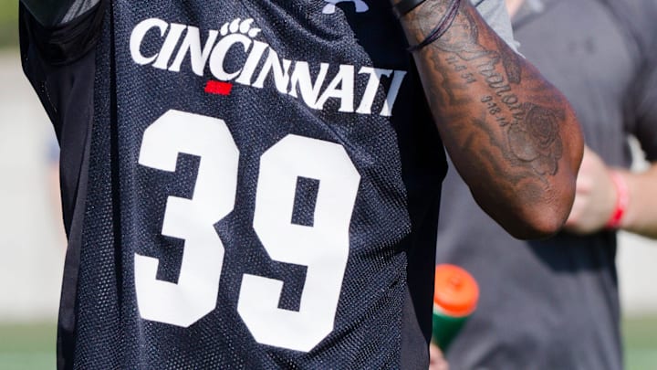 Cincinnati Bearcats safety Jaquan Sheppard (39) adjusts his helmet during Cincinnati Bearcats football practice Wednesday, July 31, 2019, at the University of Cincinnati. 

Cincinnati Bearcats 97
