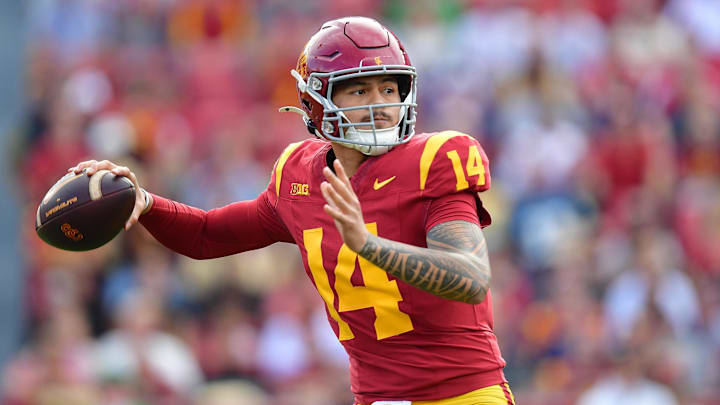 Nov 30, 2024; Los Angeles, California, USA; Southern California Trojans quarterback Jayden Maiava (14) throws against the Notre Dame Fighting Irish during the first half at the Los Angeles Memorial Coliseum. Mandatory Credit: Gary A. Vasquez-Imagn Images