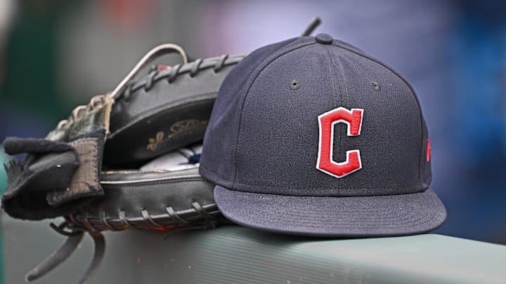 Jun 27, 2024; Kansas City, Missouri, USA; A general view a Cleveland Guardians hat and glove on the dugout railing before a game against the Kansas City Royals at Kauffman Stadium. Mandatory Credit: Peter Aiken-Imagn Images Jun 27, 2024; Kansas City, Missouri, USA; A general view a Cleveland Guardians hat and glove on the dugout railing before a game against the Kansas City Royals at Kauffman Stadium. Mandatory Credit: Peter Aiken-Imagn Images