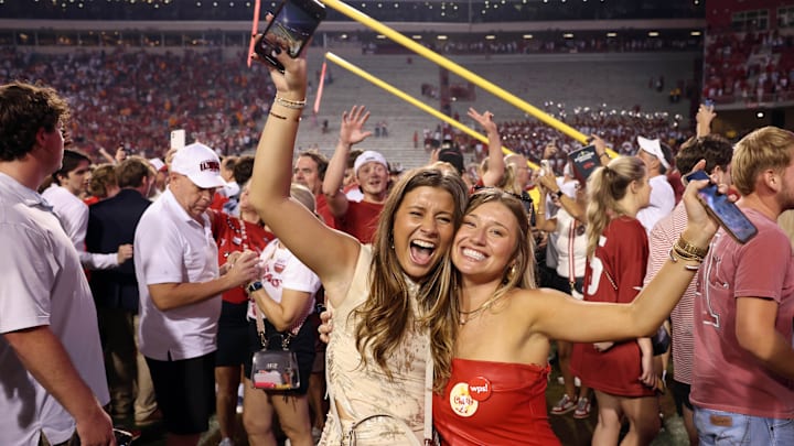 Arkansas Razorbacks fans celebrate in front of the downed goal posts after the game against the Tennessee Volunteers at Razorback Stadium. Arkansas Razorbacks fans celebrate in front of the downed goal posts after the game against the Tennessee Volunteers at Razorback Stadium.