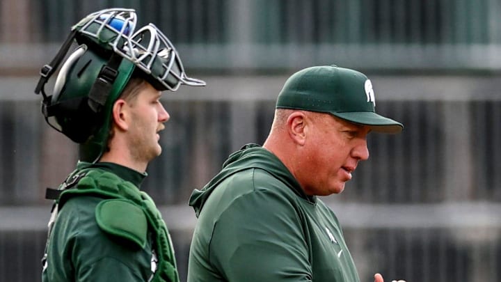 Michigan State's head coach Jake Boss Jr., center, talks to the team during a pitching change in the second inning on Wednesday, April 3, 2024, during the Crosstown Showdown against the Lugnuts at Jackson Field in Lansing.