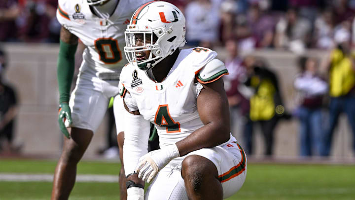 Miami Hurricanes defensive lineman Rueben Bain Jr. kneels on the field during the game between the Aggies and the Hurricanes.
