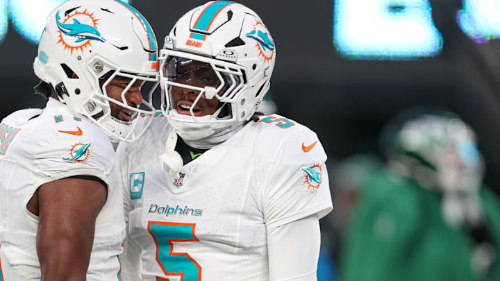 Jan 5, 2025; East Rutherford, New Jersey, USA; Miami Dolphins cornerback Jalen Ramsey (5) celebrates a defensive stop with linebacker Tyrel Dodson (11) during the first quarteragainst the New York Jets at MetLife Stadium. Mandatory Credit: Vincent Carchietta-Imagn Images