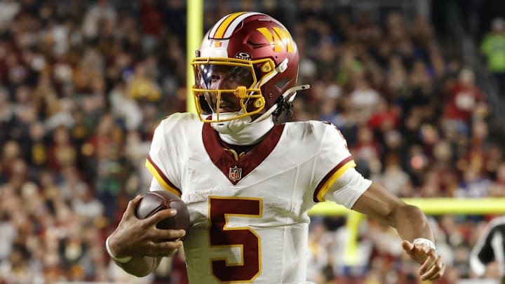 Nov 2, 2025; Landover, Maryland, USA; Washington Commanders quarterback Jayden Daniels (5) runs the ball against the Seattle Seahawks during the first half at Northwest Stadium. Mandatory Credit: Amber Searls-Imagn Images