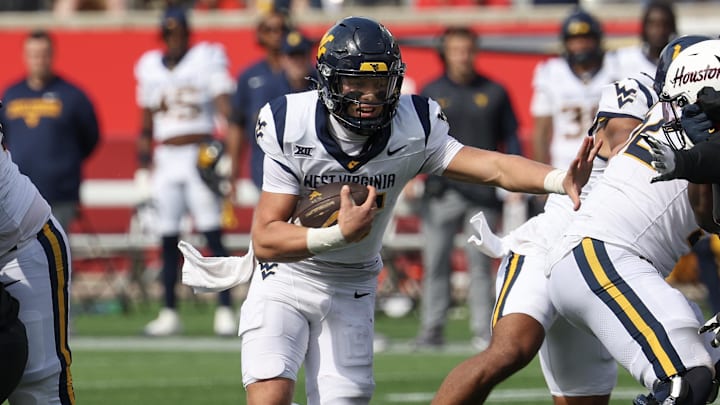 Nov 1, 2025; Houston, Texas, USA; West Virginia Mountaineers quarterback Scotty Fox Jr. (15) rushes for a touchdown against the Houston Cougars in the second half at TDECU Stadium. 