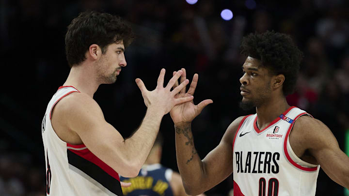 Mar 21, 2025; Portland, Oregon, USA; Portland Trail Blazers forward Deni Avdija (8) and guard Scoot Henderson (00) celebrate during the second half against the Denver Nuggets at Moda Center. Mandatory Credit: Troy Wayrynen-Imagn Images