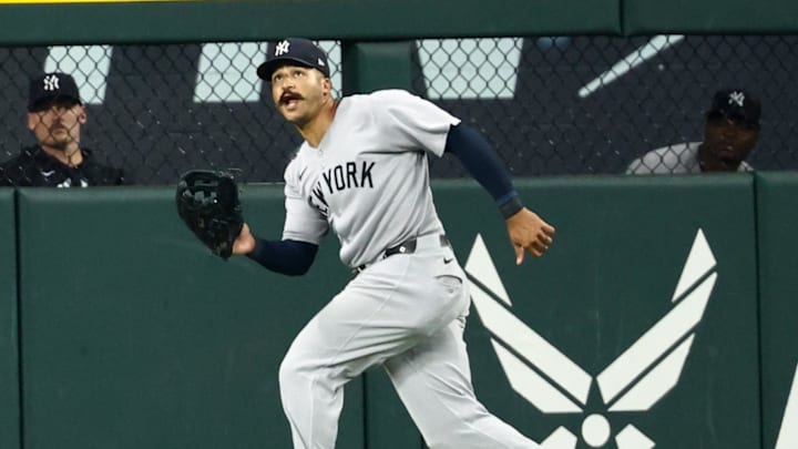 Aug 5, 2025; Arlington, Texas, USA;  New York Yankees center fielder Trent Grisham (12) makes a catch in front of New York Yankees left fielder Jasson Dominguez (24) during the seventh inning against the Texas Rangers at Globe Life Field. Mandatory Credit: Kevin Jairaj-Imagn Images