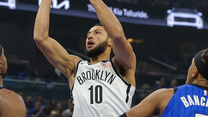 Oct 25, 2024; Orlando, Florida, USA; Brooklyn Nets guard Ben Simmons (10) shoots the ball against Orlando Magic center Wendell Carter Jr. (34) and forward Paolo Banchero (5) during the first quarter at Kia Center. Mandatory Credit: Mike Watters-Imagn Images Oct 25, 2024; Orlando, Florida, USA; Brooklyn Nets guard Ben Simmons (10) shoots the ball against Orlando Magic center Wendell Carter Jr. (34) and forward Paolo Banchero (5) during the first quarter at Kia Center. Mandatory Credit: Mike Watters-Imagn Images