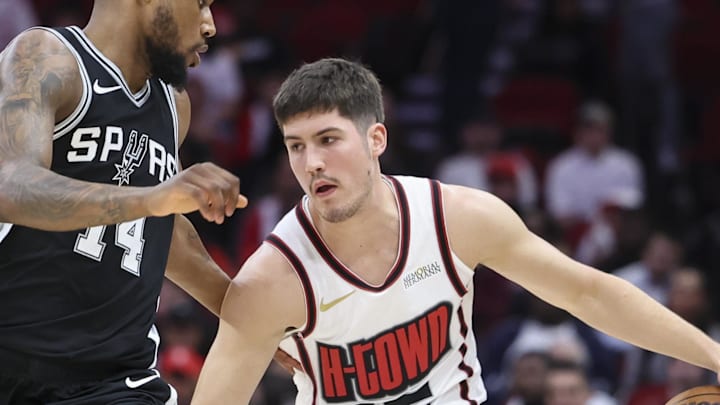 Feb 26, 2025; Houston, Texas, USA; Houston Rockets guard Reed Sheppard (15) dribbles the ball as San Antonio Spurs guard Blake Wesley (14) defends during the fourth quarter at Toyota Center. Mandatory Credit: Troy Taormina-Imagn Images
