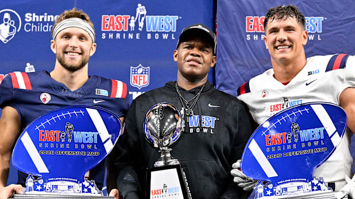 Jan 27, 2026; Frisco, TX, USA; (from left) West quarterback Mark Gronowski (11) and West head coach Lunda Wells and East edge rusher Mason Reiger (22) pose with their trophies after the game at the Ford Center at the Star. Mandatory Credit: Jerome Miron-Imagn Images