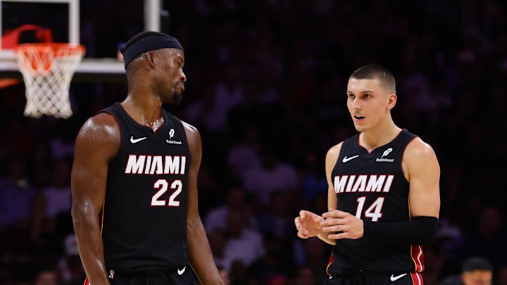 Oct 30, 2024; Miami, Florida, USA; Miami Heat forward Jimmy Butler (22) and guard Tyler Herro (14) talk on the court against the New York Knicks during the second quarter at Kaseya Center. Mandatory Credit: Sam Navarro-Imagn Images