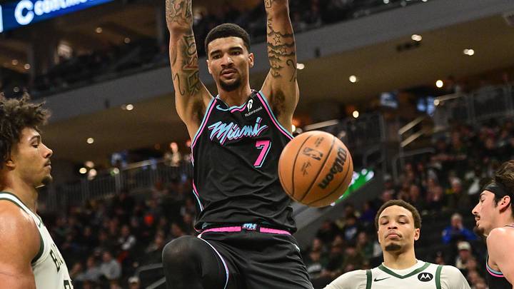 Feb 24, 2026; Milwaukee, Wisconsin, USA;  Miami Heat center Kel'el Ware (7) dunks the ball against Milwaukee Bucks center Jericho Sims (00) and guard Ryan Rollins (13) in the third quarter at Fiserv Forum. Mandatory Credit: Benny Sieu-Imagn Images