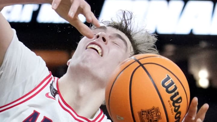 Arizona Wildcats center Motiejus Krivas (13) is fouled Saturday, April 4, 2026, by Michigan Wolverines forward Morez Johnson Jr. (21) during a Final Four game at Lucas Oil Stadium in Indianapolis.