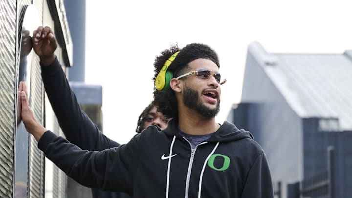 Nov 14, 2025; Eugene, Oregon, USA; Oregon Ducks quarterback Dante Moore (5) swipes his hand over the letter “O” during the “March to Victory” team walk before a game against the Minnesota Golden Gophers at Autzen Stadium. 