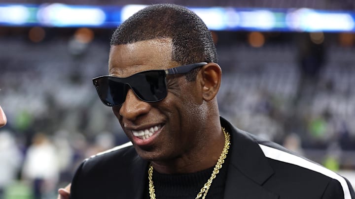 Nov 30, 2023; Arlington, Texas, USA; Colorado Buffaloes head coach Deion Sanders (right) talks with Dallas Cowboys owner Jerry Jones before the game against the Seattle Seahawks at AT&T Stadium. Mandatory Credit: Tim Heitman-Imagn Images