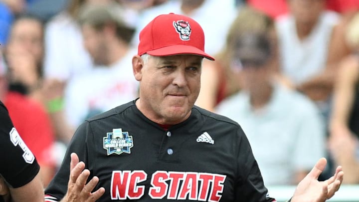 Jun 15, 2024; Omaha, NE, USA;  NC State Wolfpack head coach Elliott Avent discusses a balk call with an umpire in the game against the Kentucky Wildcats during the eighth inning at Charles Schwab Field Omaha. Mandatory Credit: Steven Branscombe-Imagn Images