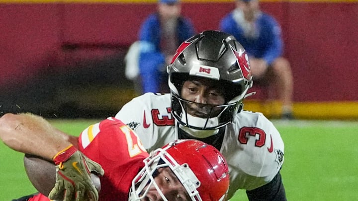 Nov 4, 2024; Kansas City, Missouri, USA; Kansas City Chiefs tight end Travis Kelce (87) runs the ball and is tackled by Tampa Bay Buccaneers safety Jordan Whitehead (3) during the game at GEHA Field at Arrowhead Stadium. Mandatory Credit: Denny Medley-Imagn Images