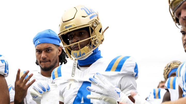 Oct 11, 2025; East Lansing, Michigan, USA; UCLA defensive back Key Lawrence (4) holds a towel with the Michigan State logo after defeating the Spartans at Spartan Stadium. Mandatory Credit: Brendan Mullin-Imagn Images