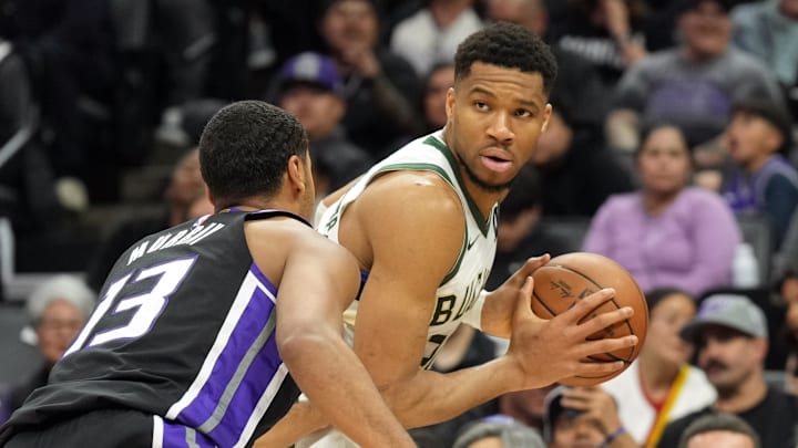 Mar 22, 2025; Sacramento, California, USA; Milwaukee Bucks forward Giannis Antetokounmpo (center) handles the ball against Sacramento Kings forward Keegan Murray (13) during the second quarter at Golden 1 Center. Mandatory Credit: Darren Yamashita-Imagn Images Mar 22, 2025; Sacramento, California, USA; Milwaukee Bucks forward Giannis Antetokounmpo (center) handles the ball against Sacramento Kings forward Keegan Murray (13) during the second quarter at Golden 1 Center. Mandatory Credit: Darren Yamashita-Imagn Images