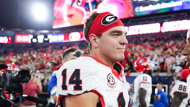 Nov 1, 2025; Jacksonville, Florida, USA; Georgia Bulldogs quarterback Gunner Stockton (14) and wide receiver Colbie Young (8) shake hands after the game against the Florida Gators at EverBank Stadium. Mandatory Credit: Matt Pendleton-Imagn Images