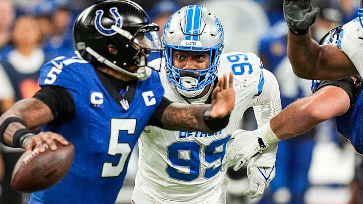 Detroit Lions defensive end Za'Darius Smith (99) pressures Indianapolis Colts quarterback Anthony Richardson (5) during the second half at Lucas Oil Stadium in Indianapolis, Ind. on Sunday, Nov. 24, 2024.