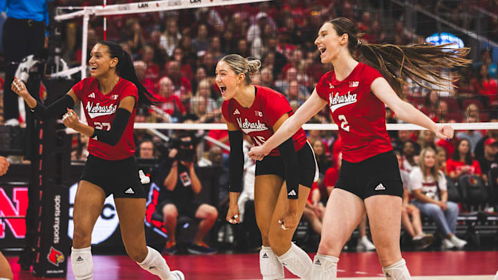 Nebraska volleyball players celebrate a point against Louisville.
