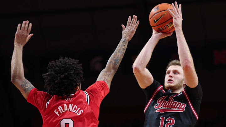 Jan 23, 2026; Piscataway, New Jersey, USA; Indiana Hoosiers forward Tucker Devries (12) shoots the ball against Rutgers Scarlet Knights guard Tariq Francis (0) during the first half at Jersey Mike's Arena.