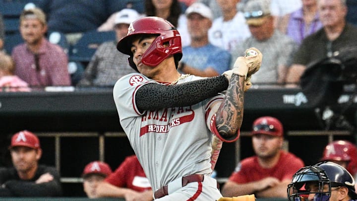 Jun 18, 2025; Omaha, Neb, USA;  Arkansas Razorbacks shortstop Wehiwa Aloy (9) singles against the LSU Tigers during the eighth inning at Charles Schwab Field. 