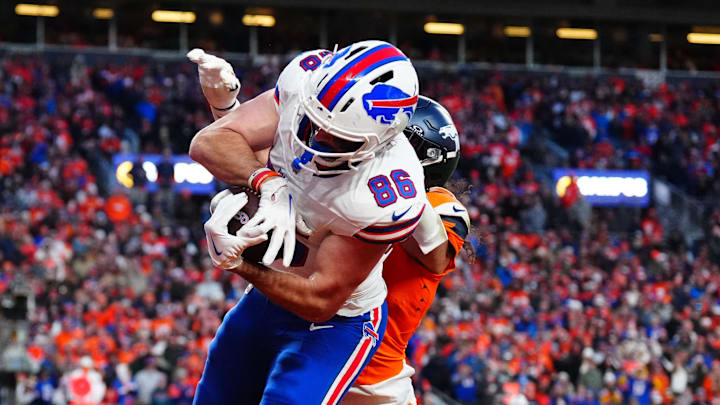 Jan 17, 2026; Denver, CO, USA; Buffalo Bills tight end Dalton Kincaid (86) catches a touchdown against Denver Broncos safety Talanoa Hufanga (9) during the fourth quarter of an AFC Divisional Round playoff game at Empower Field at Mile High. Mandatory Credit: Ron Chenoy-Imagn Images
