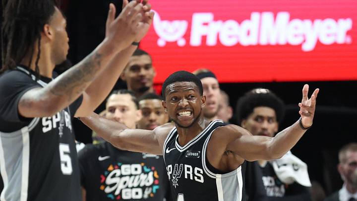 Apr 24, 2026; Portland, Oregon, USA; San Antonio Spurs guard De'aaron Fox (4) reacts after being called for a foul against the Portland Trail Blazers during the first half during game three of the first round of the 2026 NBA Playoffs at Moda Center. Mandatory Credit: Jaime Valdez-Imagn Images
