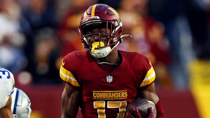 Nov 24, 2024; Landover, Maryland, USA; Washington Commanders wide receiver Terry McLaurin (17) runs for a touchdown against Dallas Cowboys cornerback Josh Butler (31) during the fourth quarter at Northwest Stadium. Mandatory Credit: Peter Casey-Imagn Images