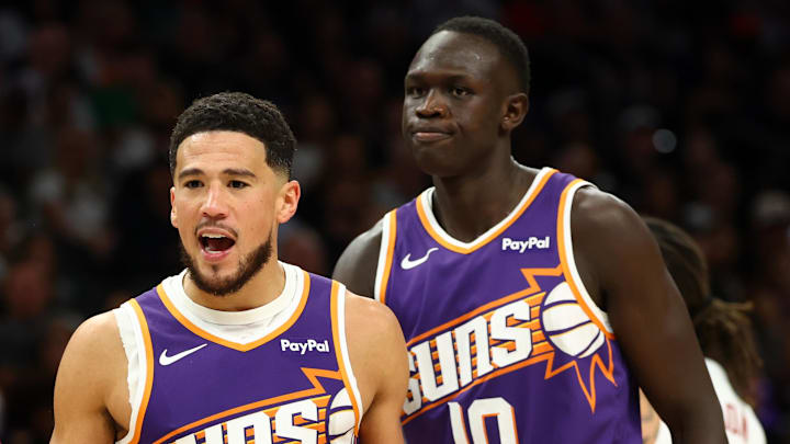 Mar 24, 2026; Phoenix, Arizona, USA; Phoenix Suns guard Devin Booker (1) argues with a referee alongside center Khaman Maluach (10) against the Denver Nuggets in the second half at Mortgage Matchup Center. Mandatory Credit: Mark J. Rebilas-Imagn Images