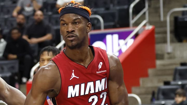 Dec 16, 2024; Detroit, Michigan, USA;  Miami Heat forward Jimmy Butler (22) passes as Detroit Pistons center Isaiah Stewart (28) defends in the first half at Little Caesars Arena. Mandatory Credit: Rick Osentoski-Imagn Images