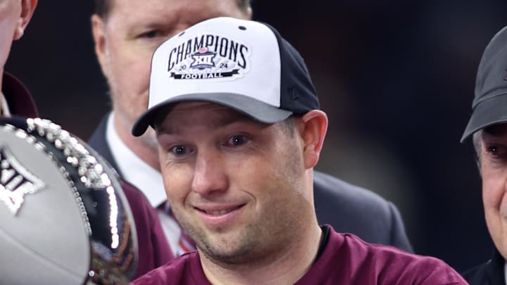 Dec 7, 2024; Arlington, TX, USA; Arizona State Sun Devils head coach Kenny Dillingham looks at the trophy after winning the Big 12 Championship game against the Iowa State Cyclones at AT&T Stadium. Mandatory Credit: Tim Heitman-Imagn Images Dec 7, 2024; Arlington, TX, USA; Arizona State Sun Devils head coach Kenny Dillingham looks at the trophy after winning the Big 12 Championship game against the Iowa State Cyclones at AT&T Stadium. Mandatory Credit: Tim Heitman-Imagn Images