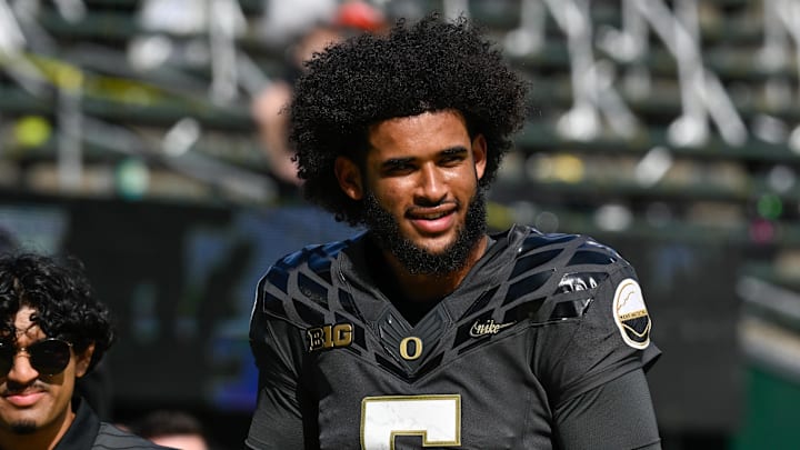 Sep 20, 2025; Eugene, Oregon, USA; Oregon Ducks quarterback Dante Moore (5) warms up before the game against the Oregon State Beavers at Autzen Stadium. Sep 20, 2025; Eugene, Oregon, USA; Oregon Ducks quarterback Dante Moore (5) warms up before the game against the Oregon State Beavers at Autzen Stadium.