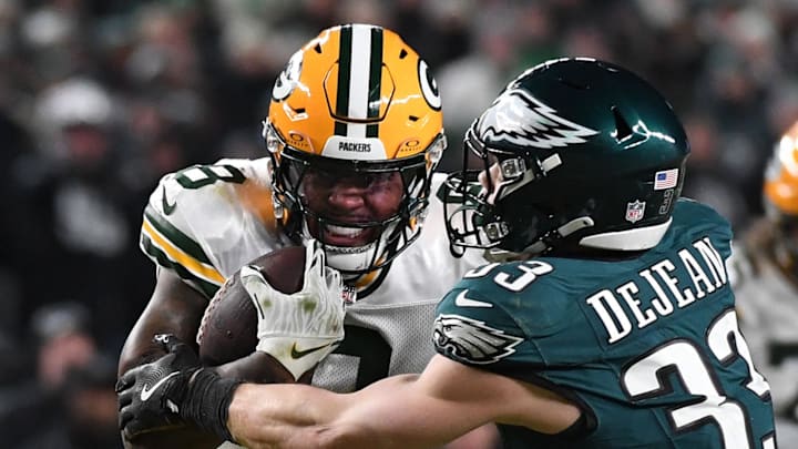 Green Bay Packers running back Josh Jacobs (8) rushes the ball against Philadelphia Eagles cornerback Cooper DeJean.