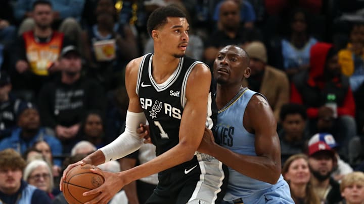 Jan 2, 2024; Memphis, Tennessee, USA; San Antonio Spurs center Victor Wembanyama (1) handles the ball as Memphis Grizzlies center Bismack Biyombo (18) defends during the first half at FedEx Forum. Mandatory Credit: Petre Thomas-Imagn Images Jan 2, 2024; Memphis, Tennessee, USA; San Antonio Spurs center Victor Wembanyama (1) handles the ball as Memphis Grizzlies center Bismack Biyombo (18) defends during the first half at FedEx Forum. Mandatory Credit: Petre Thomas-Imagn Images